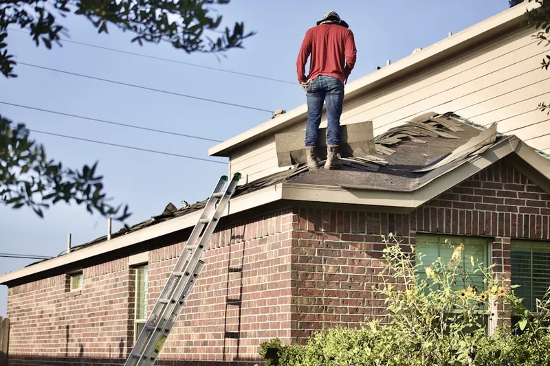 Professional roofer working on a residential roof in Liberty Meadows